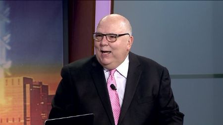 Tom Skilling in a black suit poses a picture.